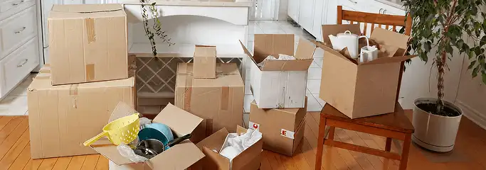 Packed moving boxes and household items in a kitchen before move-out or move-in cleaning, Orlando, FL.